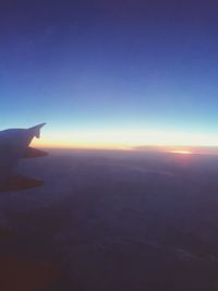 Close-up of silhouette hand against sky during sunset