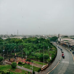 High angle view of road amidst trees during rainy season