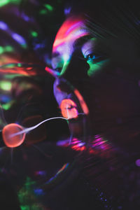 Digital composite image of woman and plasma ball with fiber optics