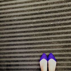 Low section of woman standing on tiled floor