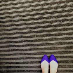 Low section of woman standing on tiled floor