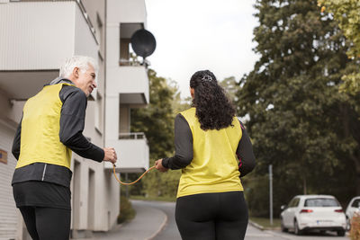 Visually impaired woman jogging with guide runner