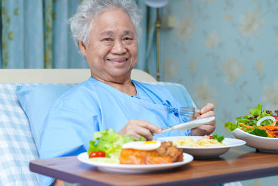 Portrait of happy woman sitting on table