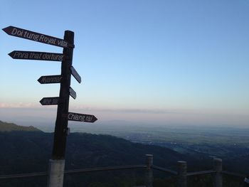 View of road sign against clear sky