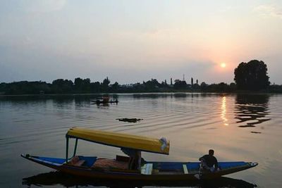 Scenic view of river at sunset