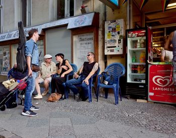 Group of people sitting on street