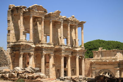 Low angle view of historical building against clear blue sky in ephesus turkey