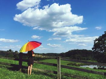 Scenic view of grassy field against cloudy sky