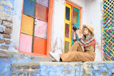 Woman with umbrella on wall