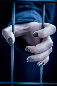 Close-up of hand holding cigarette