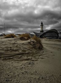 Scenic view of beach and buildings against sky