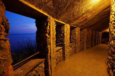 Interior of abandoned colonnade at night