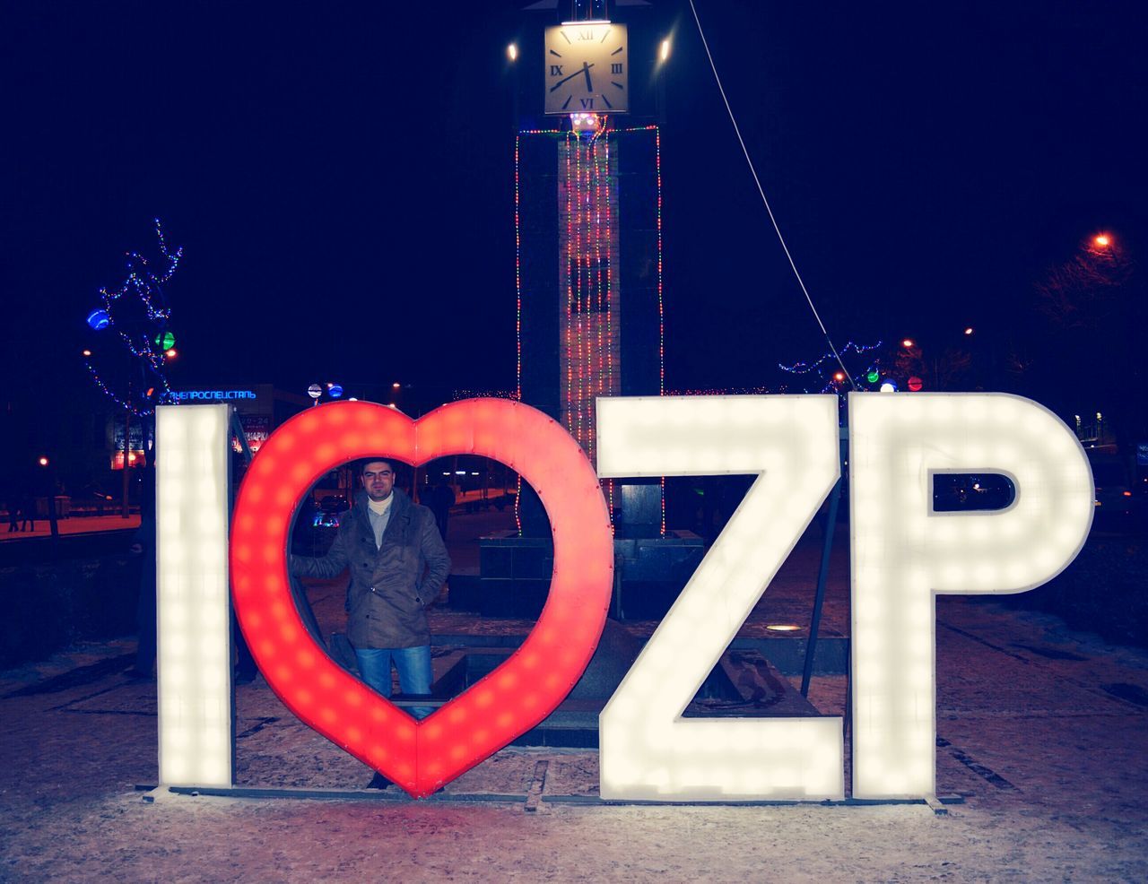 architecture, built structure, night, building exterior, illuminated, communication, red, text, city, western script, guidance, sign, capital letter, connection, outdoors, no people, tower, clear sky, metal, railing