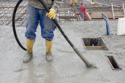 Low section of man working at construction site