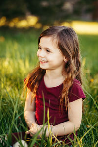 Portrait of smiling girl on field