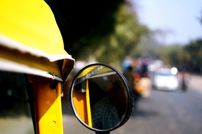 Close-up of yellow sunglasses on street