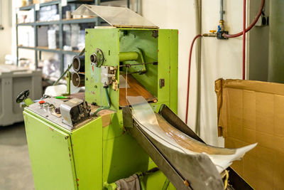 Rear view of woman standing in factory