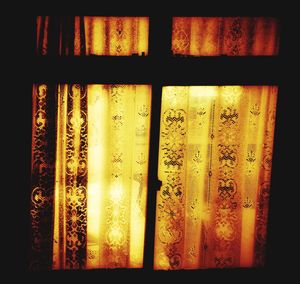 Close-up of curtain against window at home