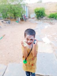 Portrait of cute boy standing outdoors