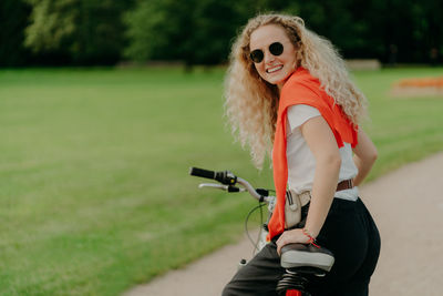 Portrait of woman wearing sunglasses standing on land