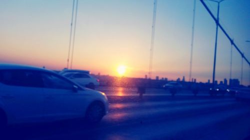 Cars on road at sunset