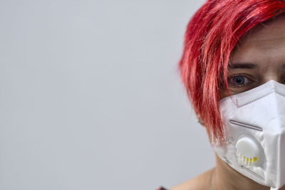 Close-up portrait of teenage girl against white background
