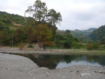 Scenic view of lake against cloudy sky