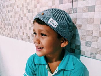Portrait of boy looking away against wall