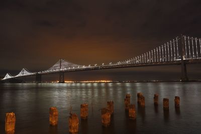 View of bay bridge illuminated at night