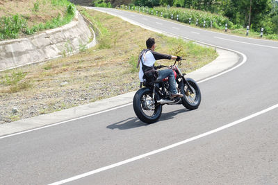 Man riding motorcycle on road