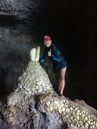 Portrait of young woman standing on rock