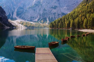 Boats on lake by mountains