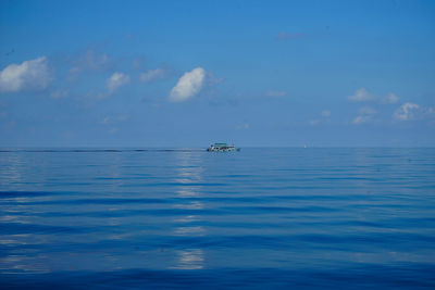 Scenic view of sea against blue sky