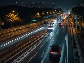 High angle view of light trails on road at night