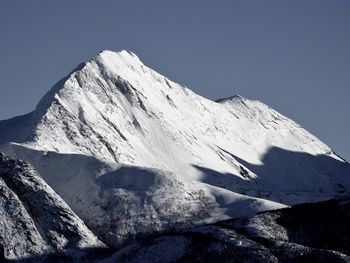 Scenic view of snowcapped mountains against clear sky