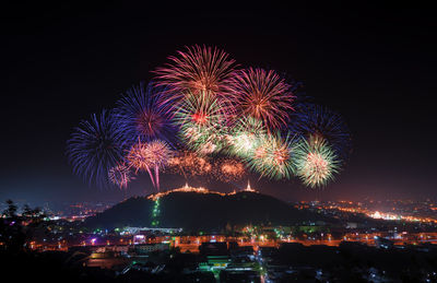 Low angle view of firework display at night