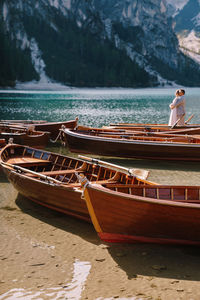 Man relaxing on boat moored at beach