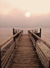 Wooden jetty on pier at sunset