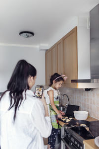 Mother and daughter in kitchen