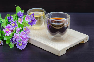 Close-up of purple and white roses on table