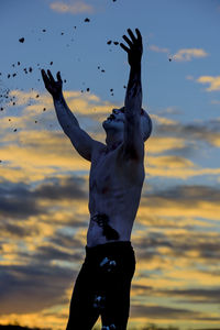 Low angle view of silhouette statue against sky during sunset