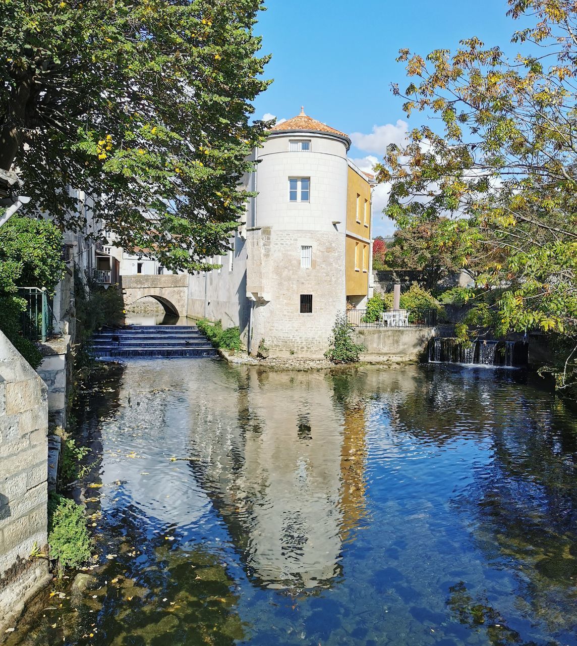 BUILDING BY LAKE AGAINST SKY