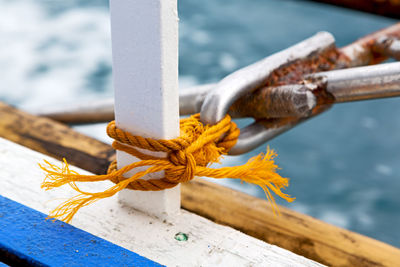 Close-up of rope tied on metal railing