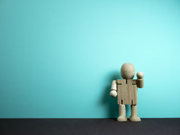 Toy on table against blue background