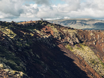 Scenic view of mountains against cloudy sky