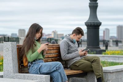 Friends sitting on railing