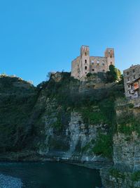 Low angle view of fort against clear blue sky