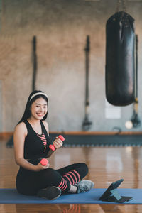 Portrait of young woman standing in gym