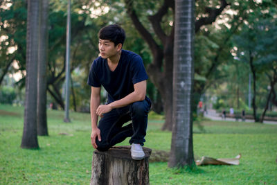 Full length of teenage girl sitting on land