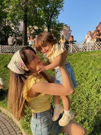 Woman and daughter while standing on plants